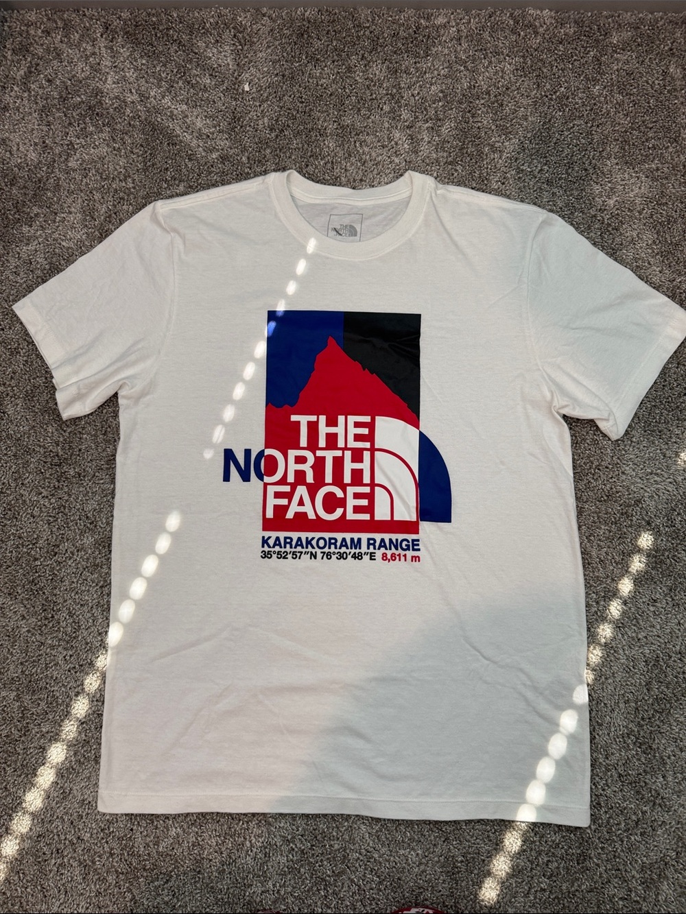 The North Face White Tee with Red & Blue Karakoram Graphic